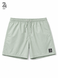 A pair of sage green athletic shorts with an elastic waistband, drawstring, and a small black '24' brand patch on the lower left leg, shown against a plain white background.